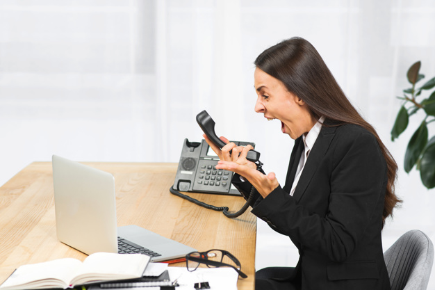 angry-young-businesswoman-sitting-chair-shouting-telephone_23-2147943650